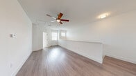 Located at 915 Diplomat Dr in Orange City, FL, this two-story home offers 2 bedrooms and 4 bathrooms across a well-organized layout. The main living level encompasses the majority of the home's footprint and features an open-concept design connecting the living room, dining room, and kitchen. The kitchen is a standout area, outfitted with white shaker cabinetry, granite countertops, a central island with a sink, subway tile backsplash, stainless steel appliances, and pendant lighting — all set atop durable wood-look flooring. The living room features a ceiling fan, natural light from multiple windows, and clean white walls with crisp trim details. Carpeted staircases with a handrail connect the two floors. The bedrooms are carpeted and bright, with windows offering natural views of the surrounding greenery. The bathrooms are finished with large-format tile surrounds, glass shower enclosures, and white vanities with stone countertops. A dedicated laundry room accommodates a full-size washer and dryer. Additional spaces include a pantry, hallway, and two closets, offering practical storage throughout. The overall aesthetic is clean, modern, and move-in ready.