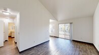 Located at 380 NW Gina Way in Beaverton, Oregon, this 2-bedroom, 2-bathroom single-floor residence offers a thoughtfully arranged layout with a variety of appealing architectural details. The living room is an immediate standout, featuring soaring vaulted ceilings and rich hardwood-style flooring that lend the space a bright, open feel. A sliding glass door opens to a private balcony, flooding the room with natural light and providing pleasant outdoor views of the surrounding neighborhood and mature trees. The kitchen is equipped with white cabinetry with wood-trimmed accents, a stainless steel gas range, and a ceiling fan overhead. A large window brings in additional natural light, and the hardwood-style flooring continues seamlessly throughout. Both bedrooms are carpeted for comfort and feature large windows that invite natural light and neighborhood views. The generously sized primary bedroom includes its own dedicated closet with a full hanging rod, while the second bedroom also benefits from dual windows and ample space. Two bathrooms serve the home, one featuring tile-style flooring, a soaking tub, and a vanity with a stone-look countertop. Two hallways connect the rooms efficiently, and two closets provide practical storage throughout.