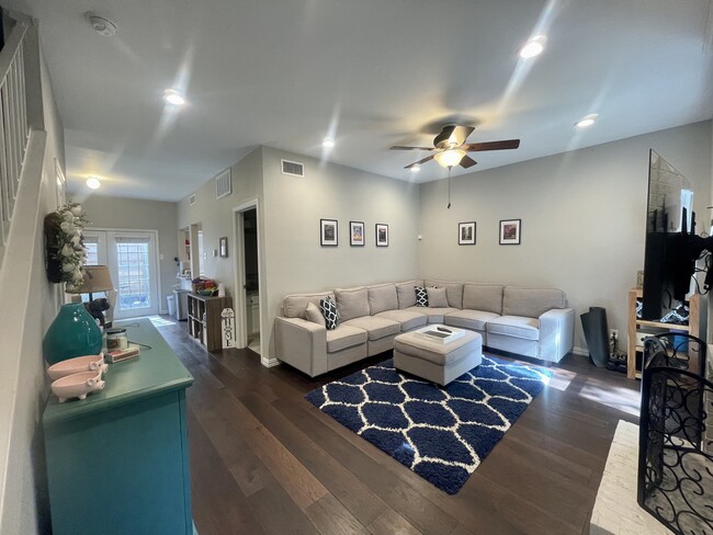 Living room with wood burning fireplace and built in TV mount - 5740 Richmond Ave