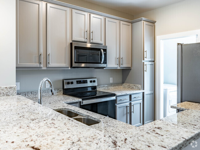 Cocina con armarios de color gris claro - East Forge Townhomes