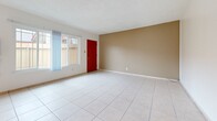 This 780 square foot single-story residence in Buena Park, California, offers a well-designed layout with two bedrooms and two bathrooms. The home features a harmonious blend of modern finishes and practical amenities. Upon entering, you're greeted by a bright living room with large windows, allowing ample natural light to flood the space. The flooring alternates between sleek tile in common areas and warm wood in the bedrooms, adding visual interest and functionality.

The kitchen, though compact, boasts rich wooden cabinetry and white tile backsplash, creating a classic yet contemporary feel. The primary bedroom, measuring 180 square feet, provides a generous space for relaxation and includes a ceiling fan for comfort. Both bathrooms feature clean lines with ample storage and modern fixtures. 

Throughout the home, neutral wall colors create a canvas for personalization, while pops of color appear in details like the striking red front door. The property's efficient use of space is evident in the thoughtful layout, which includes a dedicated closet area. This home at 6851 Dale St combines comfort and style in a manageable 780 square foot package, ideal for those seeking a cozy yet functional living space in Buena Park.