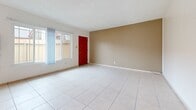 This 780 square foot single-story residence in Buena Park, California, offers a well-designed layout with two bedrooms and two bathrooms. The home features a harmonious blend of modern finishes and practical amenities. Upon entering, you're greeted by a bright living room with large windows, allowing ample natural light to flood the space. The flooring alternates between sleek tile in common areas and warm wood in the bedrooms, adding visual interest and functionality.

The kitchen, though compact, boasts rich wooden cabinetry and white tile backsplash, creating a classic yet contemporary feel. The primary bedroom, measuring 180 square feet, provides a generous space for relaxation and includes a ceiling fan for comfort. Both bathrooms feature clean lines with ample storage and modern fixtures. 

Throughout the home, neutral wall colors create a canvas for personalization, while pops of color appear in details like the striking red front door. The property's efficient use of space is evident in the thoughtful layout, which includes a dedicated closet area. This home at 6851 Dale St combines comfort and style in a manageable 780 square foot package, ideal for those seeking a cozy yet functional living space in Buena Park.