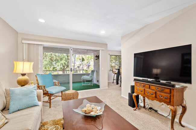 Living room with large screen TV and balcony view - 22152 Caminito Amor