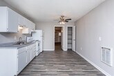 Located at 310 Northlake Dr in Warner Robins, Georgia, this single-floor home offers a practical and well-organized layout designed for comfortable everyday living. Throughout the interior, durable wood-look plank flooring provides a cohesive and clean aesthetic, complemented by neutral-toned walls and textured ceilings that add subtle character to each room.

The living area is open and inviting, featuring a wall-mounted heater unit, a window that allows natural light to filter in, and a straightforward entry door that connects to the outdoors. The space is clean and move-in ready, offering a blank canvas for personalization.

The kitchen is efficiently designed with a full run of white cabinetry providing generous upper and lower storage, a double-basin sink with laminate countertops, and white appliances including an electric coil range with oven and a full-size refrigerator. A range hood is installed above the stove for ventilation.

Additional rooms include bedrooms with closet storage and connecting hallways that allow for smooth circulation throughout the home. One room features a wall-mounted air conditioning unit, a ceiling light fixture, and an exterior door with a window, offering direct outdoor access.

Overall, this home presents a clean, functional interior with consistent finishes and practical amenities suited for residential use in Warner Robins, GA.