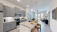 Located at 5885 Calmont Ave in Fort Worth, TX, this single-story 2-bedroom, 1-bathroom home offers a thoughtfully designed open-concept layout. The combined kitchen, dining, and living area serves as the heart of the home, showcasing gray shaker cabinetry, granite countertops, a subway tile backsplash, stainless steel appliances, and a central island with pendant lighting and bar seating. The living area benefits from abundant natural light streaming through large French doors that open to a private patio, complemented by a ceiling fan overhead. Light wood-tone flooring flows throughout the main living areas, adding warmth and continuity. Near the entry, a built-in mudroom nook provides convenient storage with shelving and hooks. The primary bedroom is generously sized, featuring plush carpet, large windows with outdoor views, and a ceiling fan. A carpeted hallway connects the bedrooms to the full bathroom, which features a navy blue vanity, tile-surround tub and shower, and wood-look flooring. Additional highlights include a dedicated laundry area, a pantry, a closet, and a patio—delivering a complete and functional living experience.