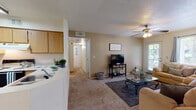 Located at 2500 N Desert Links Dr in Tucson, Arizona, this single-floor residence offers a comfortable and functional layout designed for everyday living. The open living room is generously proportioned, featuring plush carpeting, a ceiling fan, and large windows with outdoor views that fill the space with natural light. A sliding door provides direct access to the exterior, enhancing the connection to the outdoors.

The kitchen is well-appointed with light wood cabinetry, ample counter space, and a full suite of white appliances including a refrigerator, electric range, and dishwasher. Wood-look flooring runs throughout the kitchen and into the adjoining dining area, where a pendant light illuminates a cozy nook ideal for casual meals.

The two bedrooms are carpeted and comfortably sized, each featuring windows that bring in natural light. One bedroom offers a view of the outdoor pool area, adding a pleasant visual element. Ceiling fans are present for added comfort.

The bathrooms are clean and functional. The primary bathroom features warm wood-look flooring, a wide vanity with oak cabinetry, and a large mirror with overhead lighting. The secondary bathroom includes a tiled tub-shower combination and matching wood-look flooring. The overall ambiance is warm, neutral, and move-in ready.