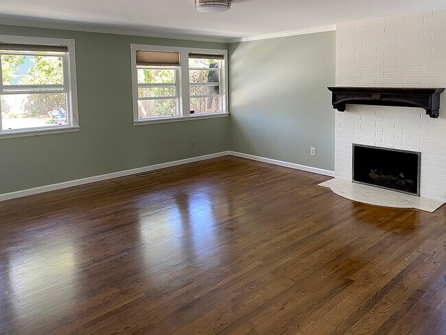 Light filled living room with hardwood floors and gas fireplace - 12830 NE 94th St