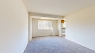 Located at 2600 W Patapsco Ave. in Baltimore, MD, this 3-bedroom, 1-bathroom unit offers a practical and efficient single-floor layout. The living area features plush carpeting and natural light from a large window, with an open sightline into the kitchen — ideal for everyday living. The kitchen is well-equipped with warm wood cabinetry, dark countertops, a gas range, dishwasher, refrigerator, and a window above the sink that brings in additional natural light. Durable tile flooring completes the kitchen space. The spacious primary bedroom features soft carpeting and a generous window with outdoor views, creating a bright and comfortable retreat. The two additional bedrooms are similarly carpeted and well-lit, each offering closet storage. The full bathroom features classic white subway tile surrounding the tub-shower combo, a white-tiled floor, a wood-cabinet vanity, and a wall mirror. A connecting hallway ties the rooms together in a clean, straightforward floor plan. Throughout the unit, neutral wall colors and consistent flooring choices provide a cohesive, move-in-ready aesthetic suited for a variety of living arrangements.