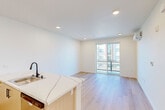 Located at 3519 Mercury Dr in Santa Maria, CA, this thoughtfully designed two-bedroom, one-bathroom unit offers a clean, modern aesthetic throughout its single-floor layout. Light wood-tone flooring flows continuously across all rooms, creating a bright and cohesive atmosphere.

The open-concept kitchen and living area serves as the heart of the unit. The kitchen features light wood cabinetry, a white quartz-style countertop with subtle veining, a stainless steel sink with a matte black faucet, and a full suite of appliances including an electric range and built-in microwave. The kitchen opens directly to the living area, which benefits from recessed lighting and a sliding glass door leading to a private balcony with exterior views.

The primary bedroom is a well-proportioned space equipped with its own wall-mounted mini-split HVAC unit for individual climate control, offering both comfort and efficiency. The second bedroom also features a mini-split system, recessed lighting, and a window that brings in natural light. Both rooms are finished with the same light wood flooring found throughout the unit.

The bathroom is clean and functional, featuring a full soaking tub with tiled surround, a toilet, and a vanity with black hardware accents. The overall design of the unit prioritizes a bright, neutral palette and modern finishes, resulting in a fresh and move-in-ready living space.