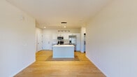 Located at 3200 Northwoods Rd in Saukville, WI, this well-designed single-story home offers three bedrooms, two bathrooms, and a thoughtfully laid-out floor plan. The open-concept living and kitchen area serves as the heart of the home, showcasing light hardwood flooring, a central island with a sink, white shaker cabinetry, and a full suite of stainless steel appliances including a range, over-the-range microwave, and French door refrigerator. Pendant and recessed lighting illuminate the space, creating a bright and welcoming atmosphere. The living area features a neutral palette and a glass-panel entry door that brings in natural light and outdoor views of the surrounding greenery. The bedrooms are carpeted for comfort, with windows providing natural light and pleasant outdoor views. Closets include wire shelving for organized storage, with a walk-in closet featured in the primary bedroom. Both bathrooms are finished with white vanities, light hardwood-style flooring, and clean, modern fixtures — one featuring a glass-enclosed shower. A carpeted hallway connects the private quarters to the main living spaces, completing a cohesive and functional layout throughout.