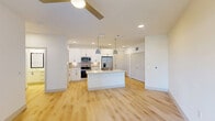 Located at 4245 Bobtown Rd in Garland, TX, this thoughtfully designed one-bedroom, one-bathroom residence offers a clean, modern aesthetic across a single floor. Light wood-style flooring runs throughout the entire unit, creating a cohesive and bright atmosphere.

The open-concept kitchen serves as the centerpiece of the living area, showcasing crisp white shaker cabinets with matte black hardware, a neutral tile backsplash, and a full suite of stainless steel appliances including a range, over-the-range microwave, and French door refrigerator. A generous kitchen island features a farmhouse-style stainless steel sink and is illuminated by stylish pendant lights, providing both prep space and a natural gathering point.

The living area extends toward a set of glass French doors that invite natural light and offer access to the patio. The bedroom is a comfortable, well-proportioned room with a ceiling fan, a window with outdoor views, and two closets for ample storage.

The bathroom is finished with clean white cabinetry, a quartz countertop, a framed mirror, and a full tub-shower combination with white subway tile surround. Additional practical spaces include a pantry, laundry area, and utility room, rounding out this efficiently designed and move-in-ready residence.