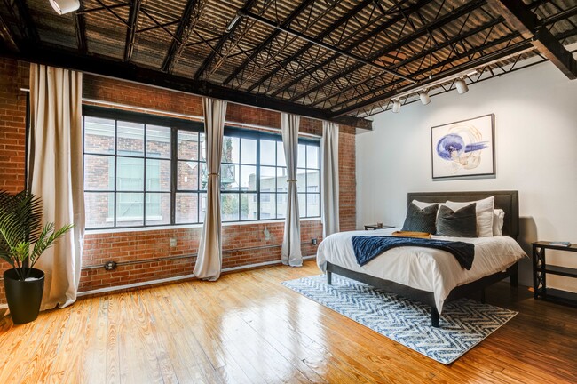 Renovated Lofts with exposed steel beams and brick accents - Mitchell Lofts