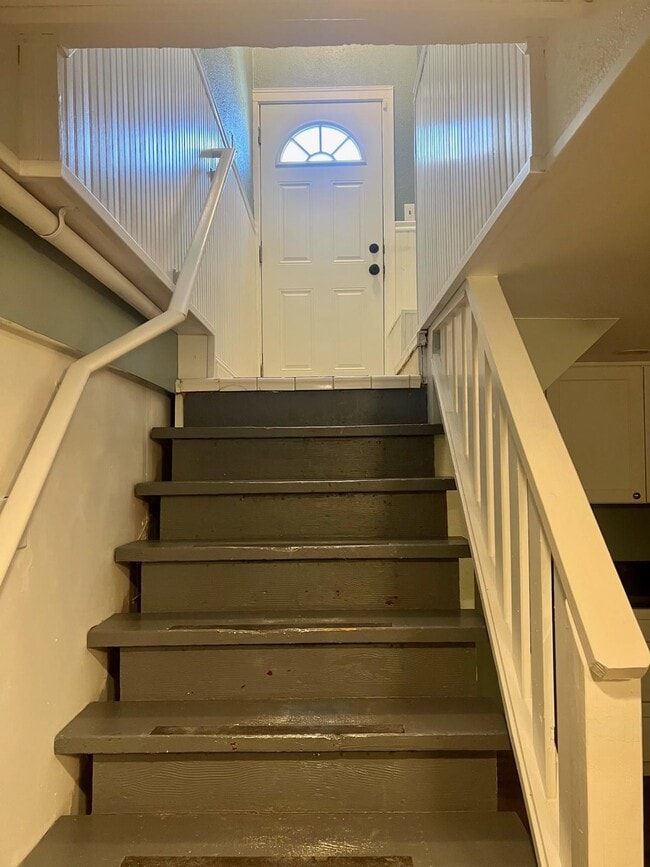 View of staircase toward exterior entry door - 428 Pacific Ter