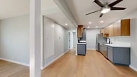 Located at 111 W Orangewood Ave in Anaheim, CA, this thoughtfully updated 2-bedroom, 1-bathroom single-story home offers a clean, modern aesthetic throughout. Light hardwood flooring runs continuously across the entire space, lending warmth and visual cohesion to every room.

The open living area is anchored by a classic white-painted brick fireplace, creating a welcoming focal point, while recessed lighting and a ceiling fan ensure comfort year-round. The layout flows naturally into a well-appointed kitchen featuring two-tone cabinetry — warm wood uppers paired with sleek gray lower cabinets — complemented by white quartz countertops, a farmhouse-style sink with a matte black faucet, and a full suite of stainless steel appliances including a refrigerator, dishwasher, and gas range.

The two bedrooms are bright and airy, each benefiting from natural light through windows with blinds and ceiling fans overhead. The primary bedroom includes a sliding-door closet, while both rooms offer a calm, neutral palette. A second closet provides additional storage elsewhere in the home.

The bathroom is finished with a clean, contemporary design, featuring a full tub-shower combo with white tile surround, a gray vanity with white countertop, and black hardware accents. A dedicated entrance completes this well-organized and move-in ready home.