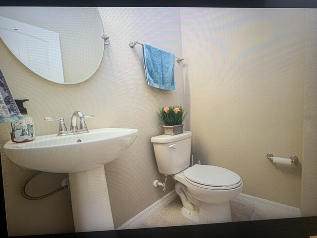 1/2 bathroom with standard pedestal sink and mirror - 8012 Olive Brook Dr