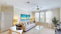 Located at 356 Lake Murray Boulevard in Columbia, SC, this well-appointed two-bedroom, two-bathroom residence offers a thoughtfully designed single-level layout with a bright, welcoming ambiance throughout. The living room is finished with soft carpet, crown molding, and a ceiling fan, and is bathed in natural light from large windows with exterior door access. The adjoining dining area continues the warm, airy feel with multiple windows dressed in patterned curtains. The kitchen is outfitted with rich dark cabinetry, granite-style countertops, stainless steel appliances including a refrigerator, range, and built-in microwave, plus light tile flooring and track lighting overhead. The primary bedroom is generously sized, featuring a ceiling fan, large windows with outdoor views, and plush carpeting. The second bedroom offers a similarly comfortable and bright retreat. Both bathrooms include dark vanity cabinetry with stone-look countertops, with the full bath featuring a tub-shower combination and tile flooring. A dedicated laundry room with shelving adds everyday convenience. Two closets provide ample storage throughout the home. The overall palette of soft neutrals and warm tones creates a cohesive, inviting atmosphere.