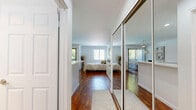 Located at 6530 Independence Ave in the Canoga Park neighborhood of Los Angeles, this efficiently designed single-floor studio offers a well-organized open-plan layout that maximizes every square foot. The main living area is finished with warm hardwood flooring and crisp white walls, creating a clean, bright atmosphere throughout. Crown molding adds a refined architectural detail to the space.

The kitchen is outfitted with white cabinetry, white appliances, and a light-toned quartz peninsula countertop that doubles as a breakfast bar, complete with two upholstered bar stools — an ideal casual dining and entertaining setup. Recessed lighting illuminates the kitchen area effectively.

The living and sleeping area is generously proportioned, benefiting from multiple windows that invite abundant natural light and offer views of greenery outside. A ceiling fan enhances comfort, and a sliding glass door leads to a private outdoor balcony, further connecting the interior to the outdoors.

The bathroom features tile flooring in earthy tones, a full-size shower-tub combination, a white vanity with ample cabinetry, and clean, all-white fixtures that contribute to its fresh, functional aesthetic. Overall, the space delivers a cohesive, light-filled environment with practical design throughout.