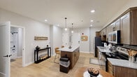 Located at 1418 Broadway in downtown Fort Wayne, Indiana, this thoughtfully designed one-bedroom, one-bathroom unit offers a modern open-concept layout with clean lines and contemporary finishes throughout. Light hardwood flooring runs seamlessly across the entire space, complementing the neutral gray-toned walls and crisp white trim.

The kitchen serves as the centerpiece of the main living area, featuring warm-toned shaker cabinetry, a dark tile backsplash, granite countertops, and a full suite of stainless steel appliances. A sizeable granite-topped island with pendant lighting above provides both additional prep space and casual seating, flowing naturally into the dining and living areas.

The living room benefits from large black-framed windows that invite natural light and offer views of the surrounding neighborhood. Recessed lighting throughout maintains a bright, open ambiance.

The bedroom is a comfortable retreat with its own window, light hardwood floors, and direct access to the bathroom and two well-organized closets featuring built-in shelving systems — offering generous storage for the space.

The bathroom continues the home's cohesive design with granite countertops, rich wood cabinetry, and black hardware accents. The overall layout is efficient yet spacious-feeling, making this a well-appointed urban residence in the heart of Fort Wayne.