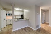 This single-floor residence offers a thoughtfully designed layout that balances comfort and functionality. The open living area features light wood-style flooring, neutral toned walls, and a textured ceiling, creating a bright and welcoming atmosphere. A classic fireplace serves as a focal point in the living room, complemented by a window that allows natural light to filter through.

The kitchen is well-equipped with white shaker-style cabinetry, granite countertops, a subway tile backsplash, and stainless steel appliances including a refrigerator and range. A peninsula counter connects the kitchen to the main living space, providing a convenient pass-through and additional seating or prep area. A window in the kitchen brings in additional natural light.

The bedrooms feature plush carpeting, neutral walls, and windows with blinds offering outdoor views. Ceiling fans add comfort, and at least one bedroom includes a dedicated walk-in closet with built-in shelving for ample storage.

The bathrooms are finished with granite-topped white vanities, dark-framed mirrors, and a full tub-shower combination. Tile-style flooring and textured walls complete the clean, updated look. Throughout the residence, consistent finishes and a neutral color palette create a cohesive and move-in-ready environment.