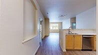 This contemporary apartment offers 980 square feet of well-designed living space on a single floor. The open-concept layout seamlessly integrates the kitchen, dining, and living areas, creating a spacious feel. The kitchen boasts wooden cabinetry, stainless steel appliances, and a practical breakfast bar. The living room features a modern fireplace and built-in shelving, with large windows allowing natural light to flood the space.

The primary bedroom, measuring 170 square feet, provides ample room and includes a closet with built-in organizers. The second bedroom also offers comfortable space and storage. Both bathrooms are outfitted with modern fixtures, including shower/tub combinations and vanities.

A dedicated laundry room with full-sized washer and dryer adds convenience. The apartment features wood-look flooring throughout, creating a cohesive and attractive aesthetic. Neutral wall colors and simple, clean lines contribute to the contemporary ambiance. With its thoughtful design and amenities, this apartment offers a comfortable and stylish living environment.