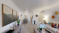 Located in Farmers Branch, Texas, this well-appointed one-bedroom, two-bathroom unit offers a thoughtfully designed single-floor layout that maximizes every square foot. Light-toned wood-look flooring flows consistently throughout the space, creating a cohesive and modern aesthetic.

The living room is bright and welcoming, featuring a large window that draws in natural light and provides views of the surrounding greenery. It connects seamlessly to a dedicated dining area, which features clean white walls and ample room for a full dining set.

The galley-style kitchen is efficiently laid out with white cabinetry, a white subway tile backsplash, marble-style countertops with a double sink, and black appliances including a refrigerator and range.

The bedroom is a comfortable retreat with a ceiling fan, a wide window overlooking outdoor greenery, and enough space to accommodate a full bedroom suite. It benefits from access to a well-appointed primary bathroom featuring a wide marble-style vanity countertop with built-in drawers, dual light fixtures, and a large mirror. The second bathroom is clean and functional, with a classic white tiled shower-tub combination. A hallway connects the main areas, completing this practical and stylish layout.