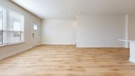 This contemporary townhome offers 1500 square feet of thoughtfully designed living space spread across two floors. The lower level comprises 670 square feet, while the upper floor expands to 840 square feet. The home boasts two bedrooms, including a generous 180-square-foot primary suite, and three full bathrooms for added convenience.

The interior is characterized by its modern aesthetic, featuring light wood flooring throughout and crisp white walls that create a bright, airy atmosphere. The open-concept kitchen is a highlight, showcasing sleek white cabinetry, stainless steel appliances, and a practical island, perfect for casual dining or food preparation.

Storage is abundant, with multiple closets and a dedicated laundry room equipped with full-sized appliances. The bathrooms are well-appointed, featuring modern fixtures and ample counter space. Large windows in the bedrooms and living areas allow natural light to flood the space, enhancing the home's overall ambiance.

An attached garage provides secure parking and additional storage options. The townhome's location in Hartland, Wisconsin, offers a balance of suburban comfort and accessibility. With its efficient layout and contemporary finishes, this property presents an attractive option for those seeking a low-maintenance, stylish living space.