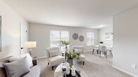 Located at 1587 Briarfield Rd in Hampton, Virginia, this single-floor, 2-bedroom, 2-bathroom home offers a well-organized layout designed for comfortable everyday living. The open-concept living and dining area is bright and welcoming, featuring soft carpet flooring, neutral gray-toned walls, and multiple windows fitted with white blinds that invite natural light throughout. The living room offers ample space for seating and flows seamlessly into a dedicated dining area with its own window and neighborhood views.

The kitchen is thoughtfully appointed with white cabinetry accented by matte black hardware, marble-look countertops, a white subway tile backsplash, and light wood-style vinyl flooring. Stainless steel appliances, including a refrigerator, range, and dishwasher, complete this functional cooking space.

The primary bedroom is generously sized with plush carpet, a large window, and a calm, neutral palette. The second bedroom is equally comfortable, also featuring carpet flooring and a window with outdoor views. Both bathrooms are clean and functional, with one featuring a full tub-shower combination accented by white tile surround and matte black fixtures. The overall ambiance throughout the home is clean, modern, and move-in ready.
