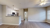 Located at 1403 Jarmel Way in Greer, SC, this single-story, one-bedroom, one-bathroom unit offers a thoughtfully designed open-concept layout across a compact yet efficient floor plan. Wood-look plank flooring runs throughout the entire space, providing a cohesive and easy-to-maintain aesthetic.

The combined living and dining area is bright and airy, with a ceiling fan overhead and a private exterior door flanked by windows that fill the space with natural light and offer pleasant outdoor views. The kitchen is positioned adjacent to the living area and features white cabinetry, granite-look countertops, black appliances including a range, dishwasher, and built-in microwave, along with a stainless steel refrigerator. Pendant lighting adds a polished touch to the kitchen, which also connects to a dedicated in-unit laundry area.

The bedroom is comfortably proportioned, featuring a ceiling fan, a window with natural light, and access to a closet. The full bathroom includes a single-sink vanity with white cabinetry, a large mirror, and a full tub-shower combination, all finished in neutral tones. Throughout the unit, warm beige walls and white trim create a clean, neutral palette suited for a variety of furnishing styles.