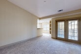 Located at 2580 Summer Lake Rd in Lithia Springs, GA, this single-story home offers a thoughtfully arranged layout with three bedrooms, three bathrooms, and a variety of functional spaces. The interior features a warm, neutral color palette with light beige walls and plush carpeting throughout the living and bedroom areas, complemented by wood-look flooring in the kitchen and bathrooms.

The kitchen is well-appointed with rich honey-toned cabinetry, granite-style countertops, a tile backsplash, and a full suite of appliances including a stainless steel refrigerator, electric range, built-in microwave, and dishwasher. Natural light streams in through multiple windows, brightening the open living area, which features an arched built-in shelving unit and a French door leading to the exterior.

The spacious primary bedroom includes its own en-suite bathroom with a double-sink vanity, wood cabinetry, a large mirror, wood-look flooring, and a separate tiled shower. Additional bathrooms are similarly finished with tub-shower combinations. Each bedroom benefits from dedicated closet space with wire shelving systems. A dedicated laundry room includes washer and dryer hookups. Two hallways connect the home's spaces efficiently, and ceiling fans in the bedrooms add comfort throughout.
