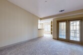 Located at 2580 Summer Lake Rd in Lithia Springs, GA, this single-story home offers a thoughtfully arranged layout with three bedrooms, three bathrooms, and a variety of functional spaces. The interior features a warm, neutral color palette with light beige walls and plush carpeting throughout the living and bedroom areas, complemented by wood-look flooring in the kitchen and bathrooms.

The kitchen is well-appointed with rich honey-toned cabinetry, granite-style countertops, a tile backsplash, and a full suite of appliances including a stainless steel refrigerator, electric range, built-in microwave, and dishwasher. Natural light streams in through multiple windows, brightening the open living area, which features an arched built-in shelving unit and a French door leading to the exterior.

The spacious primary bedroom includes its own en-suite bathroom with a double-sink vanity, wood cabinetry, a large mirror, wood-look flooring, and a separate tiled shower. Additional bathrooms are similarly finished with tub-shower combinations. Each bedroom benefits from dedicated closet space with wire shelving systems. A dedicated laundry room includes washer and dryer hookups. Two hallways connect the home's spaces efficiently, and ceiling fans in the bedrooms add comfort throughout.