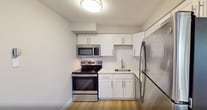 This newly renovated apartment in Philadelphia offers a well-designed living space of 940 square feet. The layout comprises three bedrooms, including a generous primary bedroom of 190 square feet, and two full bathrooms. The heart of the home is a modern kitchen featuring white cabinetry, stainless steel appliances, and a subway tile backsplash. The open concept living and dining area is illuminated by large windows, creating a bright and airy atmosphere. Light-toned wood-look flooring runs throughout, complementing the neutral wall colors. The bathrooms are outfitted with white fixtures and tiled surfaces for a clean, contemporary look. A standout feature is the balcony accessible from the living area, offering outdoor space and city views. The apartment also includes practical amenities such as in-unit climate control and ample storage solutions. With its thoughtful design and prime location at 2805 N 47th St in Philadelphia, this apartment combines comfort and urban convenience.