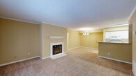 Located at 619 Arbor Station Ln in Tallahassee, Florida, this two-bedroom, three-bathroom single-story home offers a well-organized layout with a welcoming ambiance throughout. The open living area is a standout feature, anchored by a white-framed fireplace with a classic mantel and complemented by crown molding that adds a refined architectural detail. Soft carpeting flows across the living spaces, and a elegant chandelier overhead adds a touch of sophistication. French doors in the living area invite natural light and provide views of the outdoors, enhancing the airy feel of the space. The galley-style kitchen is efficiently designed with white cabinetry, subway tile backsplash, light countertops, and hardwood-style flooring, providing both functionality and a clean aesthetic. Each bedroom features plush carpeting, a ceiling fan with light fixture, and natural light from windows. The primary bedroom is generously sized, offering comfortable living space. The three bathrooms are neatly appointed with tub-shower combinations, light wood-tone flooring, and clean white fixtures. With four closets and a dedicated laundry area, storage and practicality are well addressed throughout this thoughtfully laid-out home.