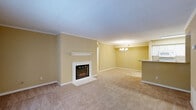 Located at 619 Arbor Station Ln in Tallahassee, Florida, this two-bedroom, three-bathroom single-story home offers a well-organized layout with a welcoming ambiance throughout. The open living area is a standout feature, anchored by a white-framed fireplace with a classic mantel and complemented by crown molding that adds a refined architectural detail. Soft carpeting flows across the living spaces, and a elegant chandelier overhead adds a touch of sophistication. French doors in the living area invite natural light and provide views of the outdoors, enhancing the airy feel of the space. The galley-style kitchen is efficiently designed with white cabinetry, subway tile backsplash, light countertops, and hardwood-style flooring, providing both functionality and a clean aesthetic. Each bedroom features plush carpeting, a ceiling fan with light fixture, and natural light from windows. The primary bedroom is generously sized, offering comfortable living space. The three bathrooms are neatly appointed with tub-shower combinations, light wood-tone flooring, and clean white fixtures. With four closets and a dedicated laundry area, storage and practicality are well addressed throughout this thoughtfully laid-out home.