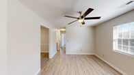 Located at 30 Spring Brooke Dr in Ringgold, GA, this single-story, 3-bedroom, 1-bathroom home offers a practical and comfortable layout. Light-toned wood-look flooring flows throughout the living areas and bedrooms, creating a clean and cohesive aesthetic. Each bedroom is equipped with a ceiling fan and light fixture, contributing to year-round comfort. The generously sized primary bedroom receives natural light through a window and includes a closet for ample storage. The two additional bedrooms are well-proportioned, with neutral walls and the same consistent flooring. The kitchen is functional and well-appointed, featuring warm honey-toned wood cabinetry, light countertops, a black electric range, a white refrigerator, and a dishwasher. Textured ceilings add a classic touch throughout the home. The full bathroom includes a tub and shower combo with clean white surround walls. A dedicated laundry room with tile flooring, shelving, and utility hookups adds everyday convenience. Three closets throughout the home provide solid storage solutions. The overall interior palette of neutral whites and warm wood tones gives the home a bright, inviting atmosphere.