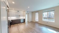 Located at North Grove in Riverside, CA, this contemporary 1-bedroom, 1-bathroom apartment offers 730 square feet of thoughtfully designed living space on a single floor. The modern kitchen is a standout feature, showcasing two-tone cabinetry with warm wood lower cabinets and crisp white upper cabinets, complemented by a marble-style tile backsplash, white quartz countertops, and a full suite of stainless steel appliances including a French door refrigerator, range, microwave, and dishwasher. Light wood-look flooring runs throughout the kitchen and main areas, adding warmth and continuity. The 120-square-foot bedroom is bright and airy, featuring plush carpet, a large window that fills the room with natural light and offers views of the surrounding community. A spacious walk-in closet with built-in wire shelving provides ample storage. The bathroom is clean and modern, featuring a wood-grain vanity with a white countertop, a large mirror, and a tub/shower combo, all finished with the same light wood-look flooring. A connecting hallway ties the layout together efficiently. The exterior of the community presents a contemporary multi-story design with balconies, manicured landscaping, and convenient parking.