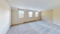 Located at 37 Farmhouse Ln in Morristown, NJ, this one-bedroom, one-bathroom residence offers a thoughtfully laid-out single-floor plan with a comfortable and functional living experience. The living room is bright and expansive, featuring large windows that invite abundant natural light, neutral-toned carpeting, and baseboard heating. A ceiling fan with lighting adds to the room's practicality and comfort.

The dedicated dining area connects seamlessly to the living space, creating an open and cohesive flow. The kitchen is efficiently designed with warm oak cabinetry, white countertops, tile flooring, and a full suite of white appliances including a refrigerator, stove, and dishwasher. A window above the counter brings in additional natural light.

The generously proportioned bedroom features plush carpeting, a ceiling fan, and multiple closet options, offering excellent storage. The full bathroom is well-appointed with warm stone-look tile surrounding the bathtub and shower, tile flooring, and a wood-toned vanity with storage below. A hallway connects the rooms with ease, and the unit benefits from five closets total, ensuring ample storage throughout. The overall ambiance is clean, neutral, and move-in ready.