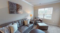 This well-appointed 2-bedroom, 2-bathroom single-floor residence offers a thoughtfully designed layout with a warm, neutral color palette throughout. The living room serves as the heart of the home, featuring elegant crown molding, plush carpeting, and large windows that invite an abundance of natural light. The space is generously sized, comfortably accommodating a full seating arrangement with room to spare.

The kitchen is designed for functionality, featuring rich dark wood cabinetry, granite-style countertops, stainless steel appliances including a full-size refrigerator and range, and durable tile flooring. A double-basin sink completes the practical workspace.

Both bedrooms are carpeted and offer a calm, restful atmosphere with neutral wall tones and ample space. Each room is served by one of the two full bathrooms, both of which include a single-sink vanity with dark wood cabinetry, tile flooring, and a shower-tub combination.

The overall ambiance of the residence is cozy and cohesive, with consistent warm tones and quality finishes throughout. A private patio extends the living space outdoors, providing an ideal spot for relaxation. This residence balances comfort and practicality in a clean, move-in-ready package.