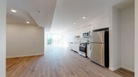 Located in the Koreatown neighborhood of Los Angeles, this modern unit at 2783 Francis Ave offers a thoughtfully designed open-concept layout finished with light-toned hardwood flooring throughout. The kitchen is a standout feature, outfitted with sleek flat-front white cabinetry, a neutral subway tile backsplash, white quartz countertops, and a full suite of stainless steel appliances including a gas range, built-in microwave, dishwasher, and refrigerator. The open living and dining area flows seamlessly from the kitchen and is bathed in natural light from large floor-to-ceiling sliding glass doors that lead to a private balcony overlooking the surrounding Los Angeles cityscape. The bedrooms are bright and airy, each featuring large windows that frame elevated views of the neighborhood skyline. The unit includes two well-appointed bathrooms: one with a combined tub and shower behind sliding glass doors, and another with a walk-in shower, both featuring floating white vanities, clean white finishes, and hardwood flooring. Recessed lighting throughout enhances the modern, minimalist aesthetic. The overall ambiance is clean, contemporary, and light-filled, offering a polished urban living experience in a prime Los Angeles location.