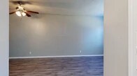 Located at 331 Crossroads Blvd in Bossier City, Louisiana, this one-bedroom, one-bathroom unit offers a practical and well-appointed single-floor layout. The welcoming entrance leads into a spacious living room finished with durable wood-look laminate flooring, neutral gray walls, white baseboards, and a ceiling fan with integrated lighting — providing both comfort and functionality. A textured ceiling adds a classic touch throughout the common areas. The kitchen is efficiently designed with crisp white cabinetry, light-toned countertops, and black appliances including an electric range, dishwasher, and under-cabinet range hood. Wood-look tile flooring ties the kitchen together, and ample upper and lower cabinet storage ensures practical use of the space. The bedroom offers a comfortable and quiet retreat, featuring plush wall-to-wall carpet, neutral warm-toned walls, and a window with blinds that allows natural light to filter in. Two doors provide access to closet storage, enhancing the room's functionality. The full bathroom is clean and straightforward, featuring a white tiled tub and shower combination with chrome fixtures and wood-look flooring. Overall, the unit presents a tidy, move-in-ready space well-suited for efficient single-occupant living.