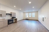 Located at 14455 East Ellsworth Avenue in Aurora, CO, this single-story residence offers three bedrooms, three bathrooms, and a well-designed layout across a generous floor plan. The open-concept living, dining, and kitchen area forms the heart of the home, featuring recessed lighting, large windows that invite natural light, and luxury vinyl plank flooring that extends throughout the entire unit. The kitchen is outfitted with modern two-tone cabinetry, granite-look countertops, a full suite of black appliances including a gas range, dishwasher, refrigerator, and built-in microwave, along with an under-cabinet range hood and a stainless steel sink. The spacious living area includes a wall-mounted HVAC unit and a triple window overlooking the exterior. Each bedroom is well-proportioned, featuring ceiling fans, individual windows with roller shades, and dedicated closets with hanging rods. The primary bedroom offers a notably generous footprint. The bathrooms are clean and functional, with full tub-shower combinations, shelved surrounds, and consistent luxury vinyl plank flooring. A combined bathroom and laundry room adds everyday convenience. The home also includes a hallway, ample closet storage, and an electrical panel for practical utility.