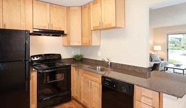Kitchens features tone countertops and updated appliances. - Plantation Gardens