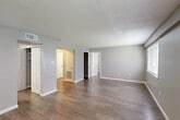Located at 515 Gardere Ln in Baton Rouge, Louisiana, this single-story 2-bedroom, 3-bathroom home offers a functional and well-appointed layout. Wood-look luxury vinyl flooring flows throughout, complementing neutral gray walls and white trim found in every room. The living room is generously sized, featuring textured ceilings and multiple doorways that connect seamlessly to the rest of the home. The kitchen is outfitted with white cabinetry, marble-style countertops, a stainless steel sink, a dishwasher, and a refrigerator, along with a window that brings in natural light. Both bedrooms are comfortably sized, each featuring ceiling fans, wood-look flooring, and windows with blinds that offer outdoor views. The primary bedroom includes a closet and direct access to one of the three bathrooms. The bathrooms are clean and functional, featuring tub-shower combos and marble-style vanity countertops. Two dedicated closets provide practical storage throughout the home. A dedicated laundry room houses a full-size washer and dryer alongside the electrical panel, adding convenience. The overall ambiance is clean, bright, and move-in ready, making this a practical and comfortable home in Baton Rouge.