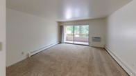 Located at 617 Regency Square in Kalamazoo, MI, this single-floor unit offers a practical and comfortable layout with a neutral, light-filled aesthetic throughout. The living area is generously proportioned, featuring wall-to-wall carpeting, baseboard heating, and large windows fitted with vertical blinds that invite natural light and frame views of surrounding greenery. A sliding glass door opens directly onto a private balcony, extending the living space outdoors and providing pleasant outdoor views.

The kitchen is functionally designed with dark wood cabinetry offering ample storage, granite-style laminate countertops, tile flooring, and an electric range, providing a clean and efficient workspace.

The bedrooms are carpeted and well-sized, each featuring built-in closet systems with sliding or bifold doors that maximize storage capacity. The warm-toned wood interior doors add a classic touch throughout the unit.

The bathroom is notably spacious, presenting a double-sink vanity with granite-style countertops, a wide mirror, and tile flooring. A separate enclosed tub-shower combination with mosaic tile flooring completes the space. Overall, the unit maintains a clean, neutral palette with a functional and straightforward design suited to everyday living.