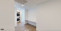 Located at 1950 Mayfair St in Naples, FL, this thoughtfully designed 2-bedroom, 3-bathroom residence offers a bright and contemporary living experience. Light wood-tone flooring flows consistently throughout, complementing the clean white walls and modern finishes that define the space.

The open-concept kitchen is a standout feature, showcasing high-gloss white cabinetry, quartz countertops, stainless steel appliances including a range, microwave, dishwasher, and refrigerator, a herringbone tile backsplash, and sleek pendant lighting over a generous island. The kitchen connects seamlessly to the combined dining and living area, where floor-to-ceiling sliding glass doors flood the space with natural light and frame expansive elevated views of the Naples skyline and surrounding greenery.

Both bedrooms are well-proportioned and bright, with the primary bedroom also benefiting from large sliding glass doors and scenic outdoor views. Two walk-in closets provide ample storage. The three bathrooms are finished in a clean, modern style — one features a pedestal sink with a backlit mirror, while another includes a tub-shower combination with quartz vanity countertops. A stacked in-unit washer and dryer with a built-in folding counter adds everyday convenience to this polished Naples residence.