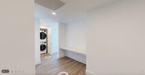 Located at 1950 Mayfair St in Naples, FL, this thoughtfully designed 2-bedroom, 3-bathroom residence offers a bright and contemporary living experience. Light wood-tone flooring flows consistently throughout, complementing the clean white walls and modern finishes that define the space.

The open-concept kitchen is a standout feature, showcasing high-gloss white cabinetry, quartz countertops, stainless steel appliances including a range, microwave, dishwasher, and refrigerator, a herringbone tile backsplash, and sleek pendant lighting over a generous island. The kitchen connects seamlessly to the combined dining and living area, where floor-to-ceiling sliding glass doors flood the space with natural light and frame expansive elevated views of the Naples skyline and surrounding greenery.

Both bedrooms are well-proportioned and bright, with the primary bedroom also benefiting from large sliding glass doors and scenic outdoor views. Two walk-in closets provide ample storage. The three bathrooms are finished in a clean, modern style — one features a pedestal sink with a backlit mirror, while another includes a tub-shower combination with quartz vanity countertops. A stacked in-unit washer and dryer with a built-in folding counter adds everyday convenience to this polished Naples residence.