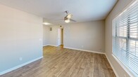 This 540 square foot apartment in North Charleston offers a thoughtful layout maximizing space efficiency. The open-concept living area seamlessly integrates the living room and kitchen, creating a spacious feel. The living room boasts wood-look flooring and a large window, providing natural light and a view of the outdoors. 

The kitchen, while compact, is well-equipped with modern appliances, including a stainless steel refrigerator and stove. White cabinetry and granite-look countertops offer both style and functionality. A window above the sink allows for natural light and ventilation.

The bedroom, measuring 150 square feet, features plush carpeting and a ceiling fan for comfort. It includes a large window with blinds for light control and privacy. The bathroom, though not spacious, is functional with a combined tub and shower unit.

Throughout the apartment, neutral-toned walls and textured ceilings create a clean, contemporary aesthetic. Ceiling fans in main living areas provide air circulation. The property's single-floor design enhances accessibility, making it an ideal choice for those seeking a low-maintenance living space in a convenient location.