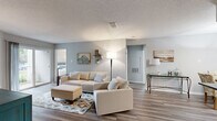 Located at 150 Arbors Cir in Gahanna, OH, this well-appointed 2-bedroom, 2-bathroom single-floor home offers a thoughtfully designed layout with modern finishes throughout. The living room serves as the heart of the space, featuring vaulted ceilings, wood-look flooring, a tiled fireplace, and a sliding glass door that floods the room with natural light and provides outdoor access. The kitchen is outfitted with white shaker cabinetry, dark granite countertops, stainless steel appliances including a gas range and French door refrigerator, and a peninsula with a sink that opens to the adjacent dining area — ideal for everyday living and entertaining. Both bathrooms are finished with white vanities, round mirrors, and wood-look tile flooring, offering a clean, contemporary aesthetic. The primary bedroom is a comfortable retreat with plush carpeting, natural light from a window, and generous proportions. The second bedroom mirrors the same cozy feel with soft carpet and a window view. Additional highlights include a dedicated laundry area, hallway storage, and two closets, making this home as functional as it is inviting.
