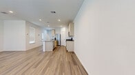 This two-story home offers a thoughtfully designed layout spread across two floors, providing ample living space for comfortable everyday living. The main floor hosts an open-concept kitchen and living area, where light hardwood-style flooring flows seamlessly throughout. The kitchen is a standout feature, equipped with stainless steel appliances including a French door refrigerator, gas range, dishwasher, and built-in microwave. Light wood cabinetry pairs with granite countertops, and a central island with an undermount sink adds both functionality and style. Recessed lighting brightens the space throughout.

The upper floor houses all three bedrooms, four bathrooms, a dedicated laundry room, and a walk-in closet. The generously sized primary bedroom features multiple windows that invite natural light, along with a ceiling fan for added comfort. The walk-in closet offers built-in shelving and hanging rods for organized storage. The bathrooms are finished with clean white subway tile surrounds in the tub-shower combinations and matching hardwood-style flooring. A dedicated laundry room with a full-size washer and dryer adds everyday convenience. Neutral white walls and consistent flooring throughout lend the home a cohesive, modern aesthetic.