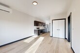 Located at 820 Trail Rd in Sedro-Woolley, WA, this well-designed one-bedroom, one-bathroom unit offers a thoughtfully organized single-level layout. The open-concept living and kitchen area is anchored by light wood-style flooring that extends throughout the main living spaces, creating a bright and cohesive aesthetic. The kitchen features dark espresso cabinetry paired with light countertops and a full suite of stainless steel appliances, including a range, microwave, dishwasher, and refrigerator. The contrast of dark cabinet frames and door trim against the white walls adds a clean, contemporary character to the space. The living area receives natural light through a sliding door that opens to an outdoor balcony. The spacious primary bedroom is finished with plush carpeting and features two closets with sliding doors, offering ample storage. A window in the bedroom frames outdoor views and allows natural light to fill the room. The bathroom includes a full tub-shower combination, light wood-style flooring, and a dark-framed vanity consistent with the unit's modern design language. Recessed and flush-mount lighting throughout ensures well-lit interiors, and the overall clean, neutral palette makes this a versatile and functional living space.
