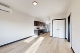 Located at 820 Trail Rd in Sedro-Woolley, WA, this well-designed one-bedroom, one-bathroom unit offers a thoughtfully organized single-level layout. The open-concept living and kitchen area is anchored by light wood-style flooring that extends throughout the main living spaces, creating a bright and cohesive aesthetic. The kitchen features dark espresso cabinetry paired with light countertops and a full suite of stainless steel appliances, including a range, microwave, dishwasher, and refrigerator. The contrast of dark cabinet frames and door trim against the white walls adds a clean, contemporary character to the space. The living area receives natural light through a sliding door that opens to an outdoor balcony. The spacious primary bedroom is finished with plush carpeting and features two closets with sliding doors, offering ample storage. A window in the bedroom frames outdoor views and allows natural light to fill the room. The bathroom includes a full tub-shower combination, light wood-style flooring, and a dark-framed vanity consistent with the unit's modern design language. Recessed and flush-mount lighting throughout ensures well-lit interiors, and the overall clean, neutral palette makes this a versatile and functional living space.